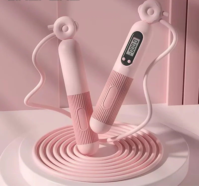 Corde à sauter connectée rose avec écran numérique pour suivre les performances d'entraînement