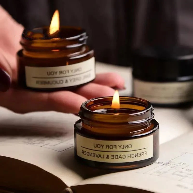 Bougie aromathérapie en verre brun avec une flamme, parfum fraîcheur cade et lavande, idéale pour la détente