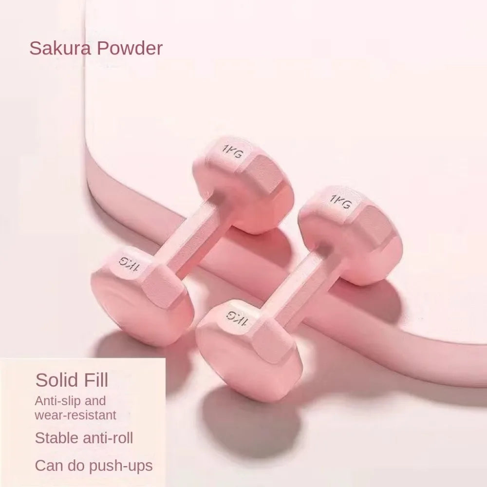 Petits haltères colorés en rose avec une finition anti-glisse et résistante pour l'entraînement